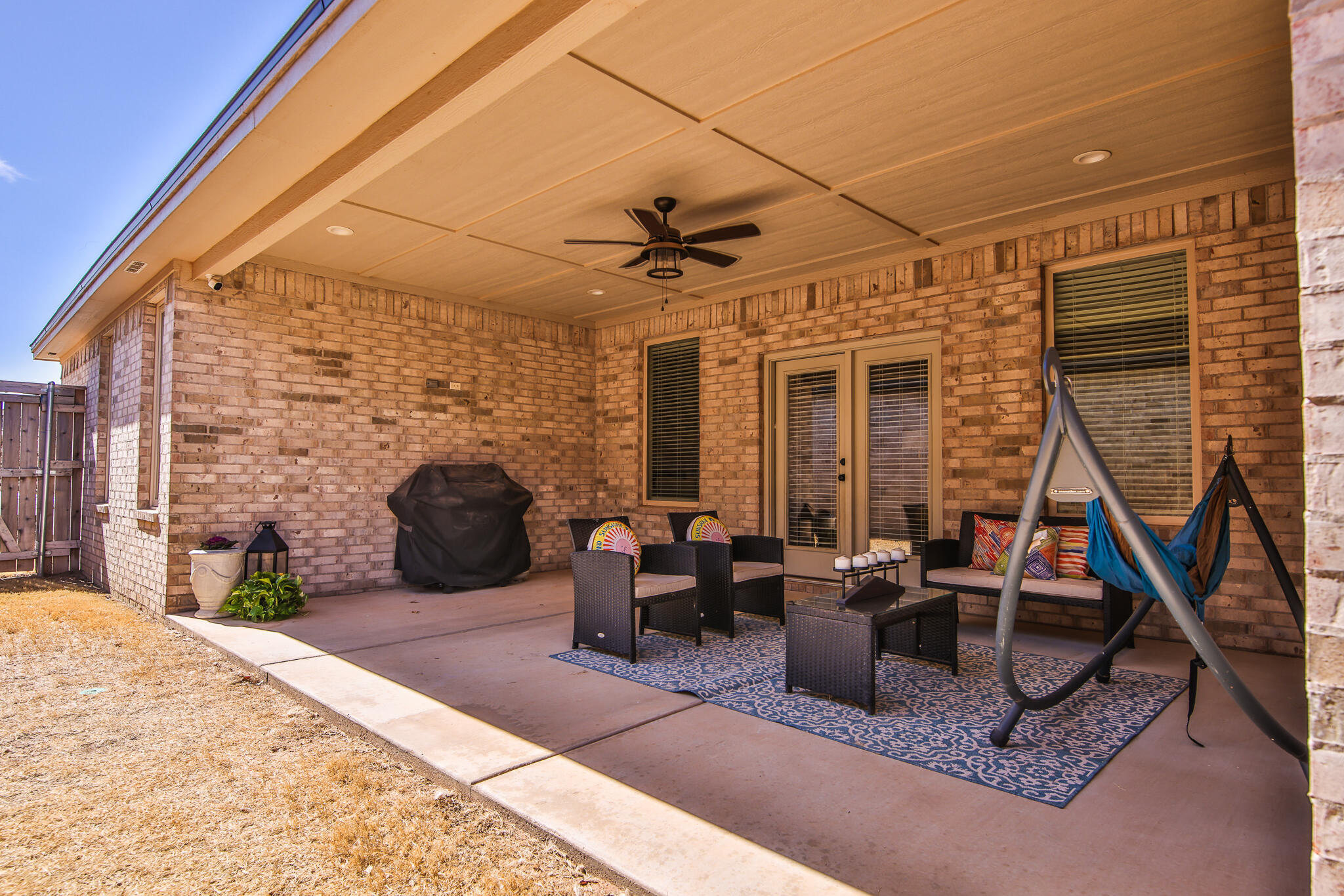 3806 59th Street Lubbock, TX 79413 - Photo 36 of 38 a living room with furniture a fireplace and a floor to ceiling window