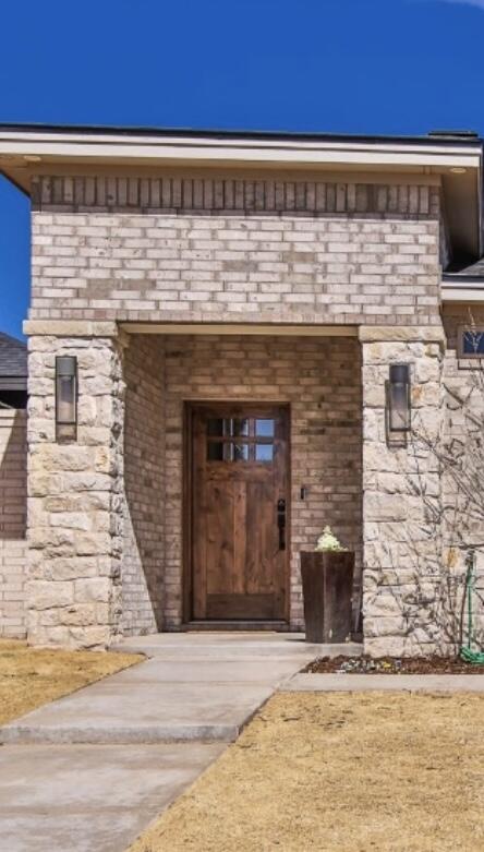 3806 59th Street Lubbock, TX 79413 - Photo 5 of 38 a front view of a building with a glass door