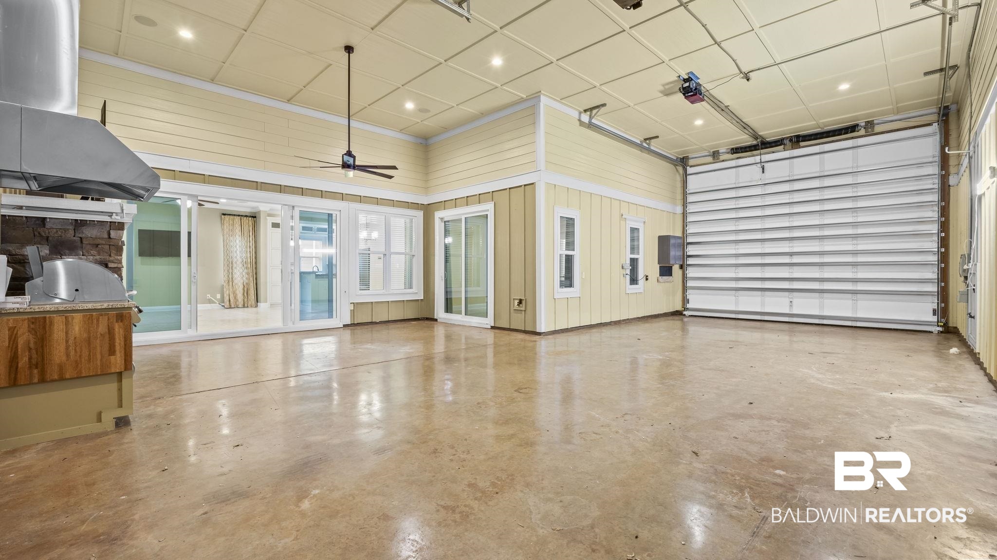 12361 Reunion Place Foley, AL 36535 - Photo 16 of 43 Garage featuring recessed lighting, wood walls, and ceiling fan