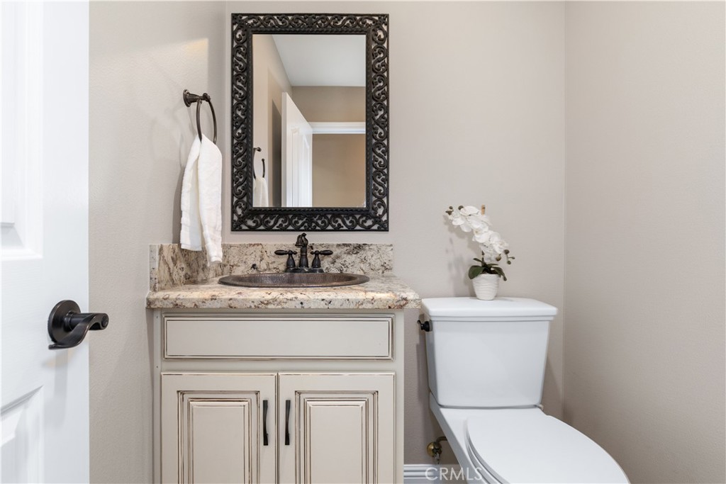 1275 Shane Lane Templeton, CA 93465 - Photo 31 of 70 a bathroom with a granite countertop toilet sink and mirror