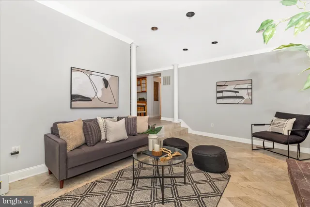 a living room with furniture and wooden floor