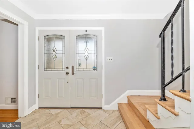 a view of a livingroom with wooden floor and a bathroom