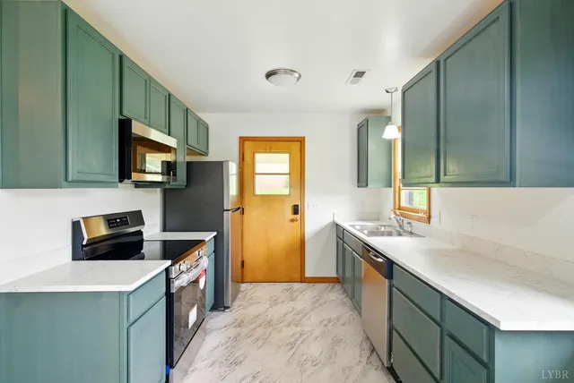 a kitchen with a sink stove top oven and refrigerator