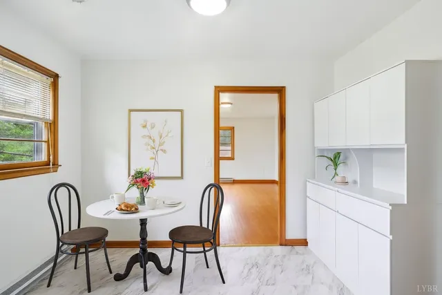 a dining room with furniture and window