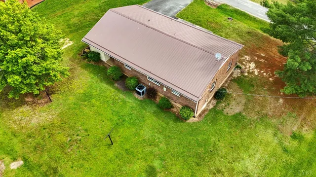 a view of a house with backyard sitting area and garden