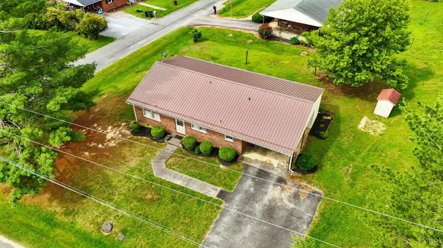 an aerial view of a house with garden space and street view