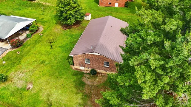 a backyard of a house with yard and trampoline