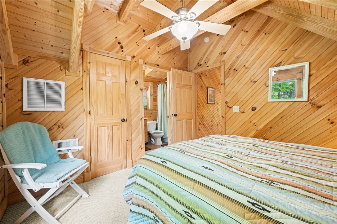 613 Silas Creek Road Lansing, NC 28643 - Photo 23 of 40 a bedroom with a bed and wooden floor
