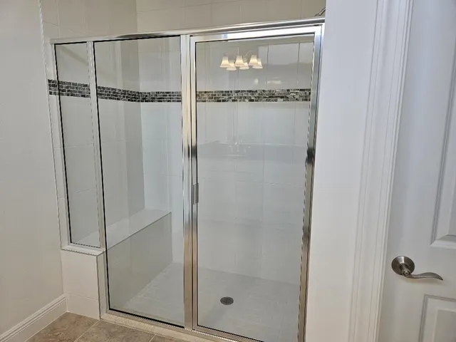 a bathroom with a glass shower door