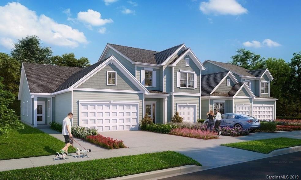 a front view of a house with a garden and yard