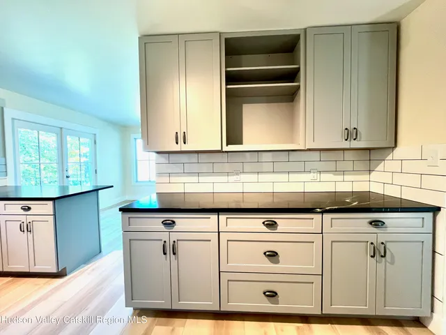 a view of white cabinets and sink