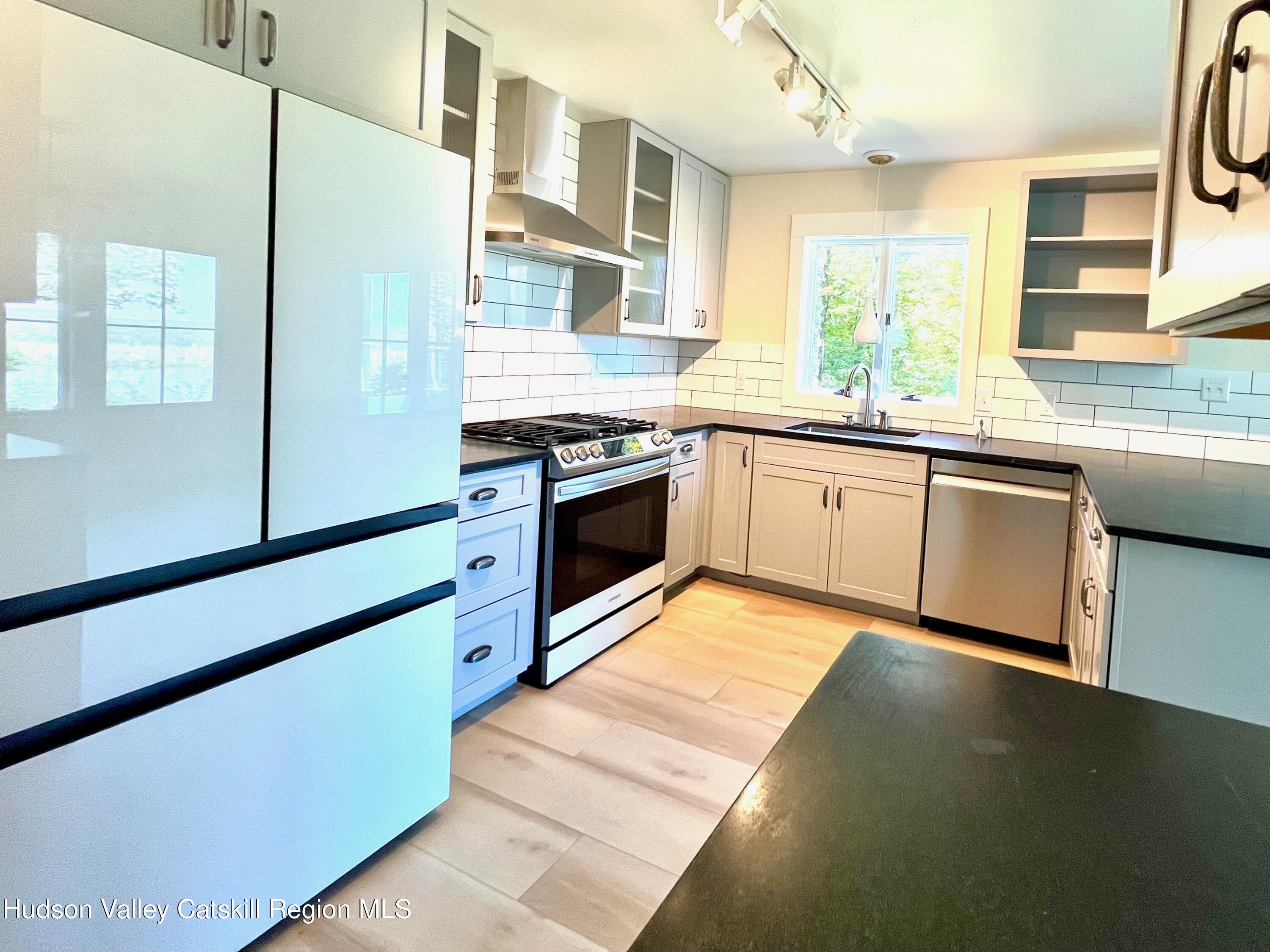 5265 County Rt 9g Germantown, NY 12526 - Photo 12 of 32 a kitchen with stainless steel appliances granite countertop a stove a sink and a refrigerator
