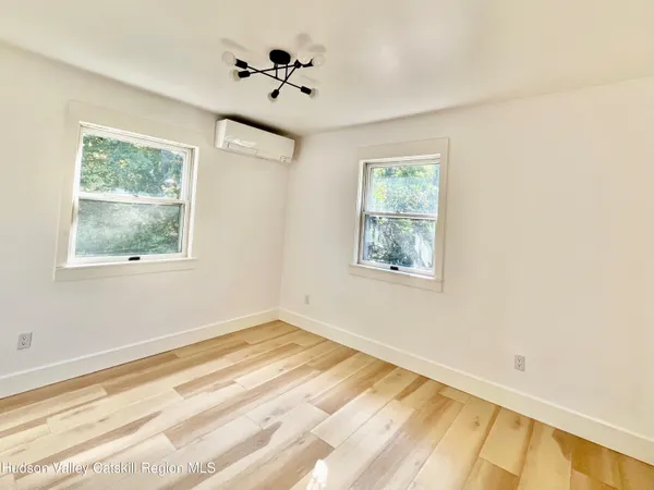 a bathroom with a granite countertop toilet a sink and a mirror
