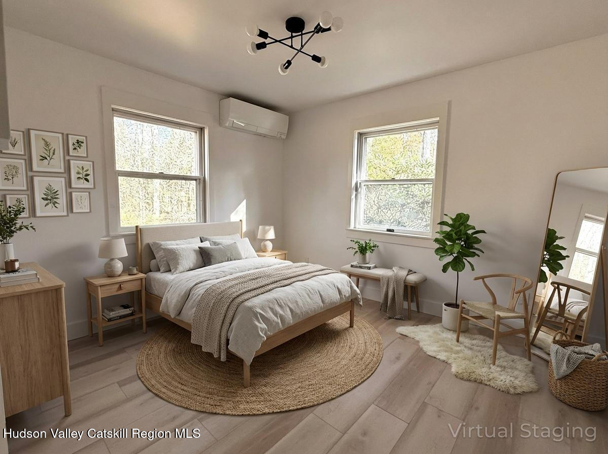 5265 County Rt 9g Germantown, NY 12526 - Photo 15 of 35 a spacious bedroom with a bed a chandelier and windows