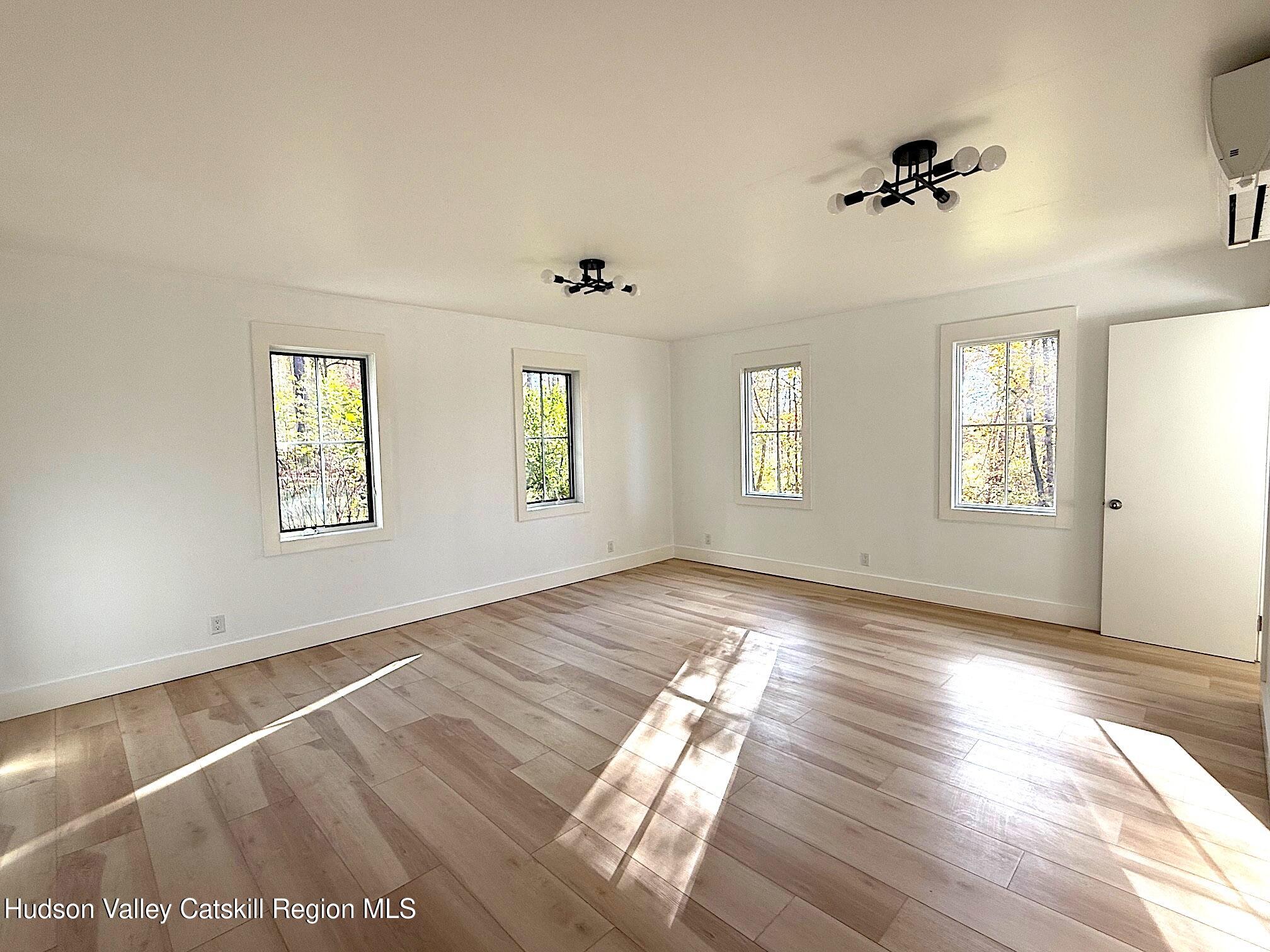 5265 County Rt 9g Germantown, NY 12526 - Photo 20 of 35 an empty room with wooden floor and windows