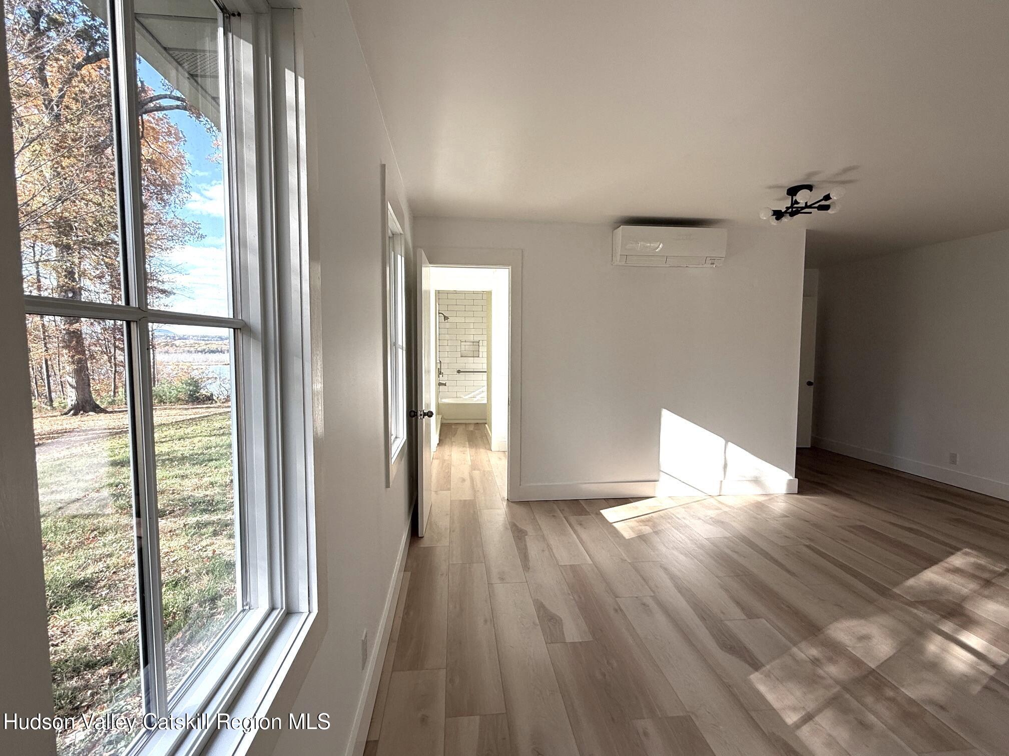 5265 County Rt 9g Germantown, NY 12526 - Photo 22 of 35 a view of empty room with wooden floor and fan