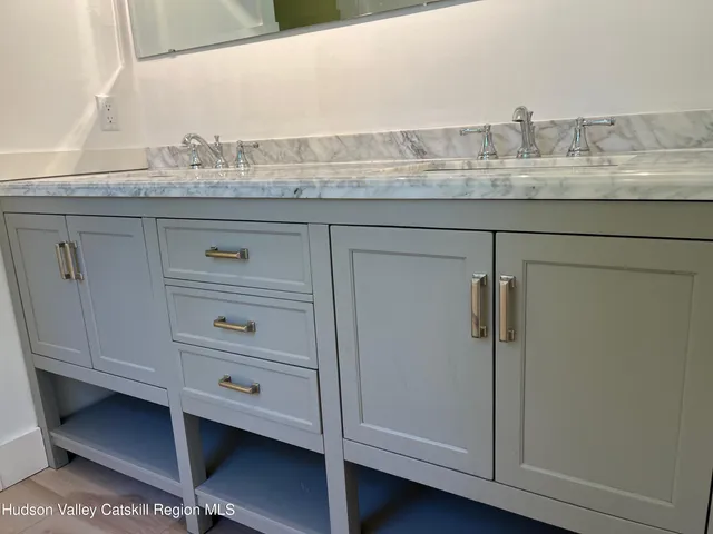 a bathroom with a granite countertop cabinets and toilet
