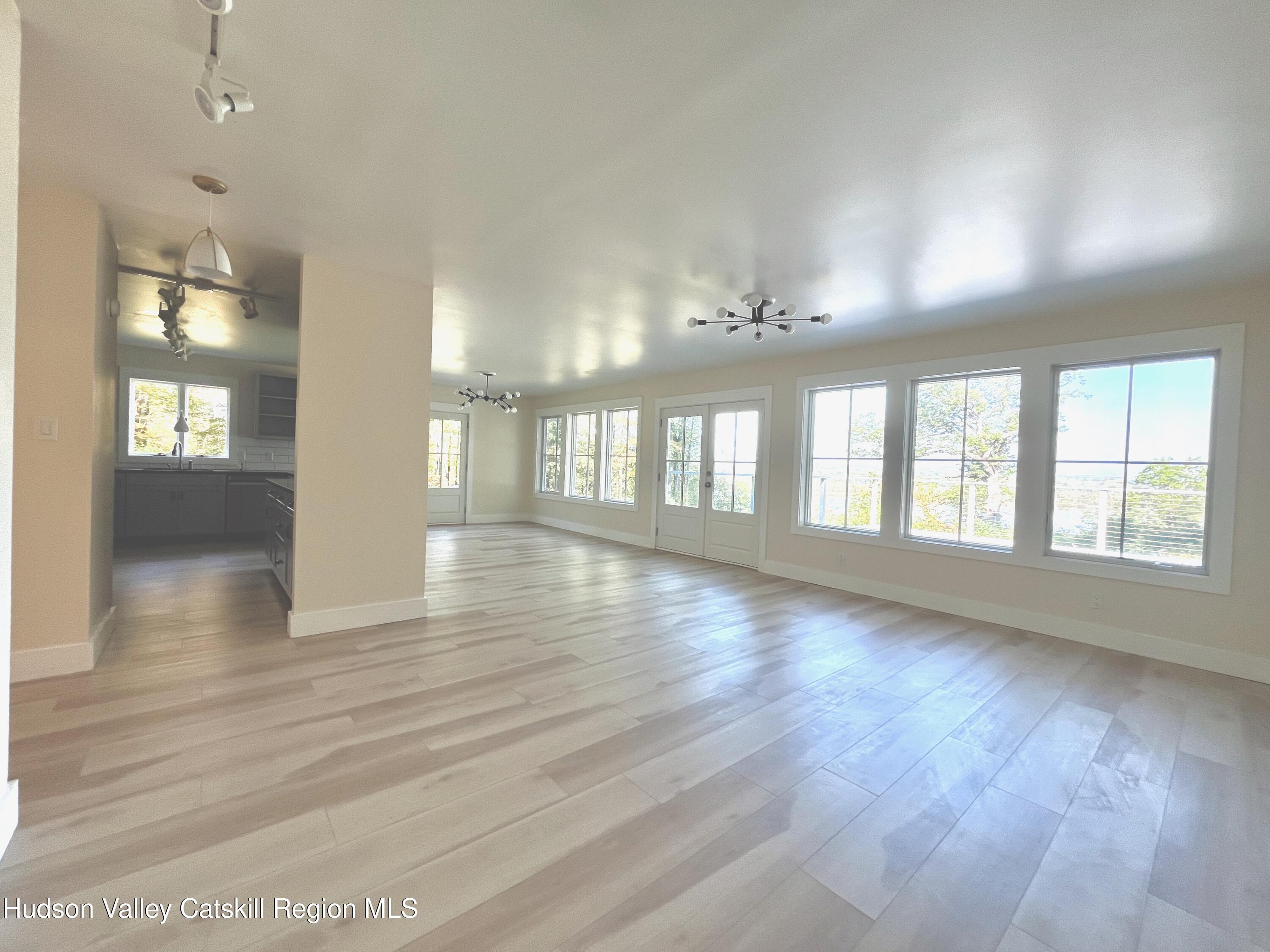 5265 County Rt 9g Germantown, NY 12526 - Photo 3 of 32 an empty room with wooden floor and windows