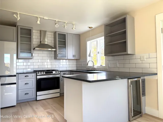 a kitchen with stainless steel appliances granite countertop a sink and a stove