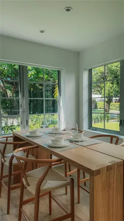 a dining room with furniture and window