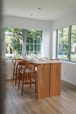 a view of a room that has a window and wooden floor