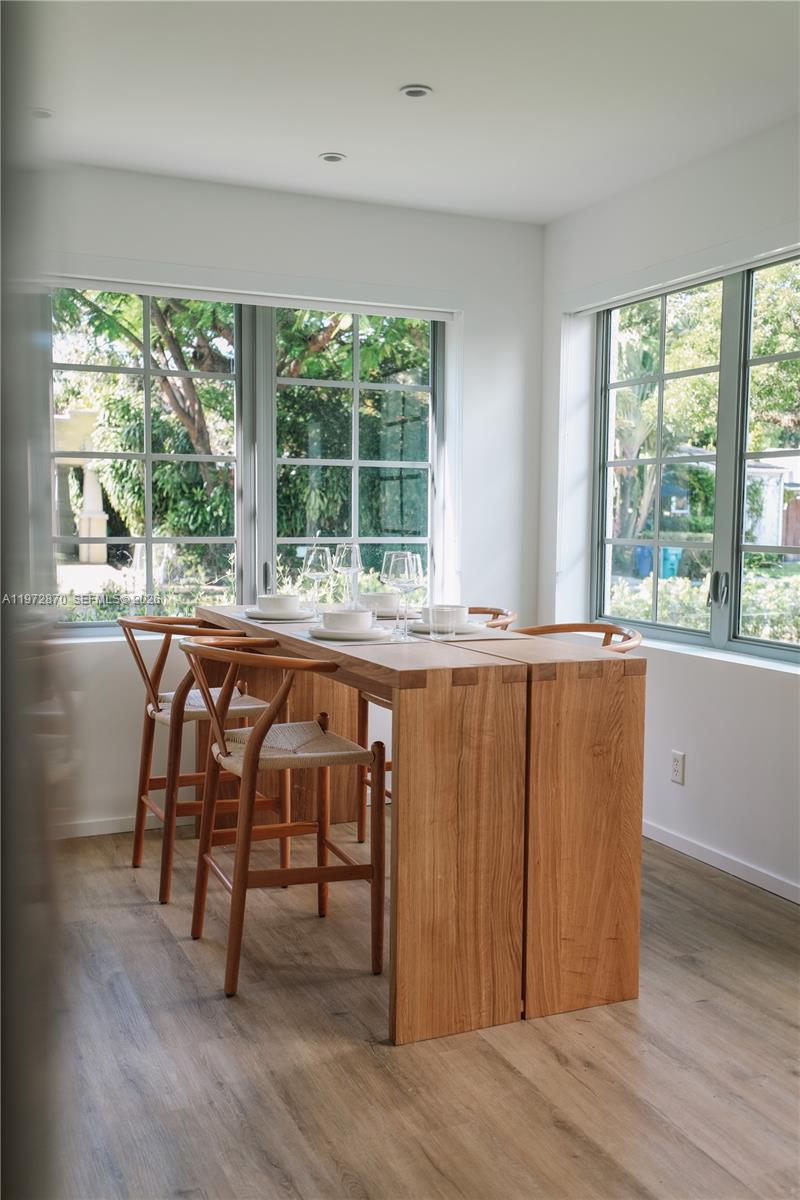 128 Northeast 46th Street, Unit 3 Miami, FL 33137 - Photo 3 of 17 a view of a room that has a window and wooden floor