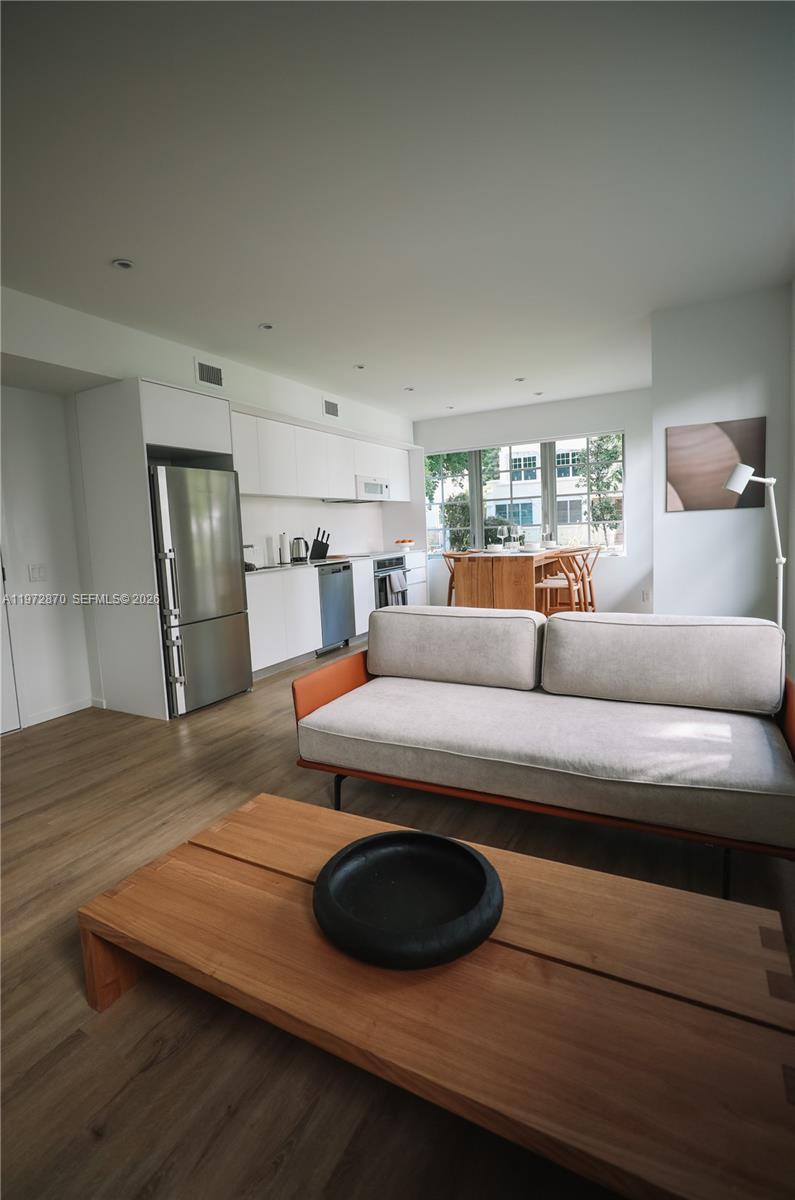 128 Northeast 46th Street, Unit 3 Miami, FL 33137 - Photo 6 of 17 a living room with furniture and a wooden floor