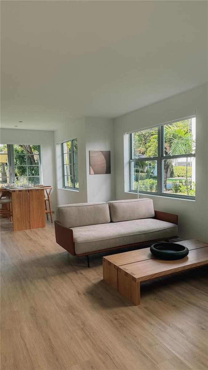 128 Northeast 46th Street, Unit 3 Miami, FL 33137 - Photo 9 of 17 a living room with furniture and a large window