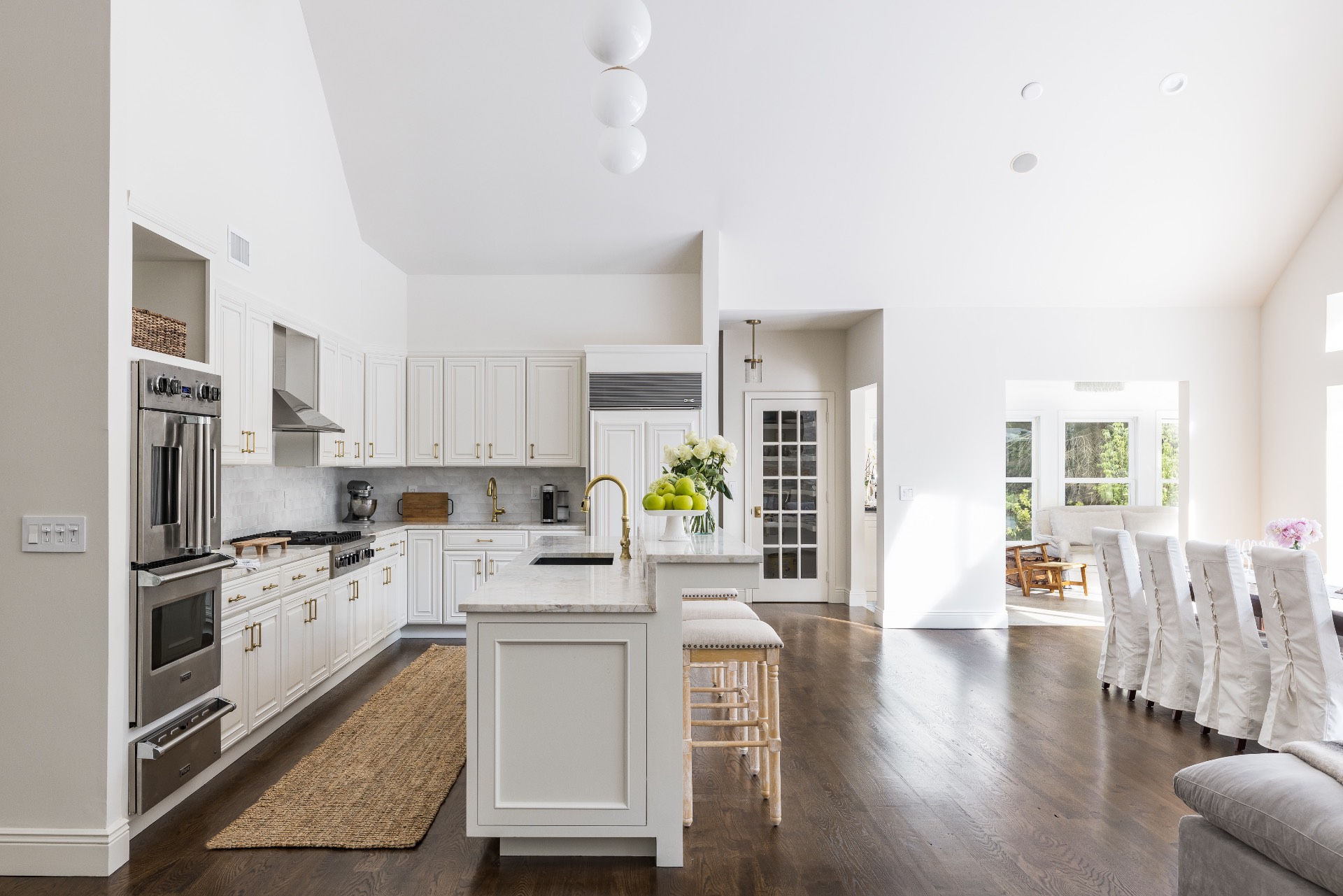 222 2 Holes Water Road East Hampton, NY 11937 - Photo 12 of 32 a kitchen with white cabinets and stainless steel appliances