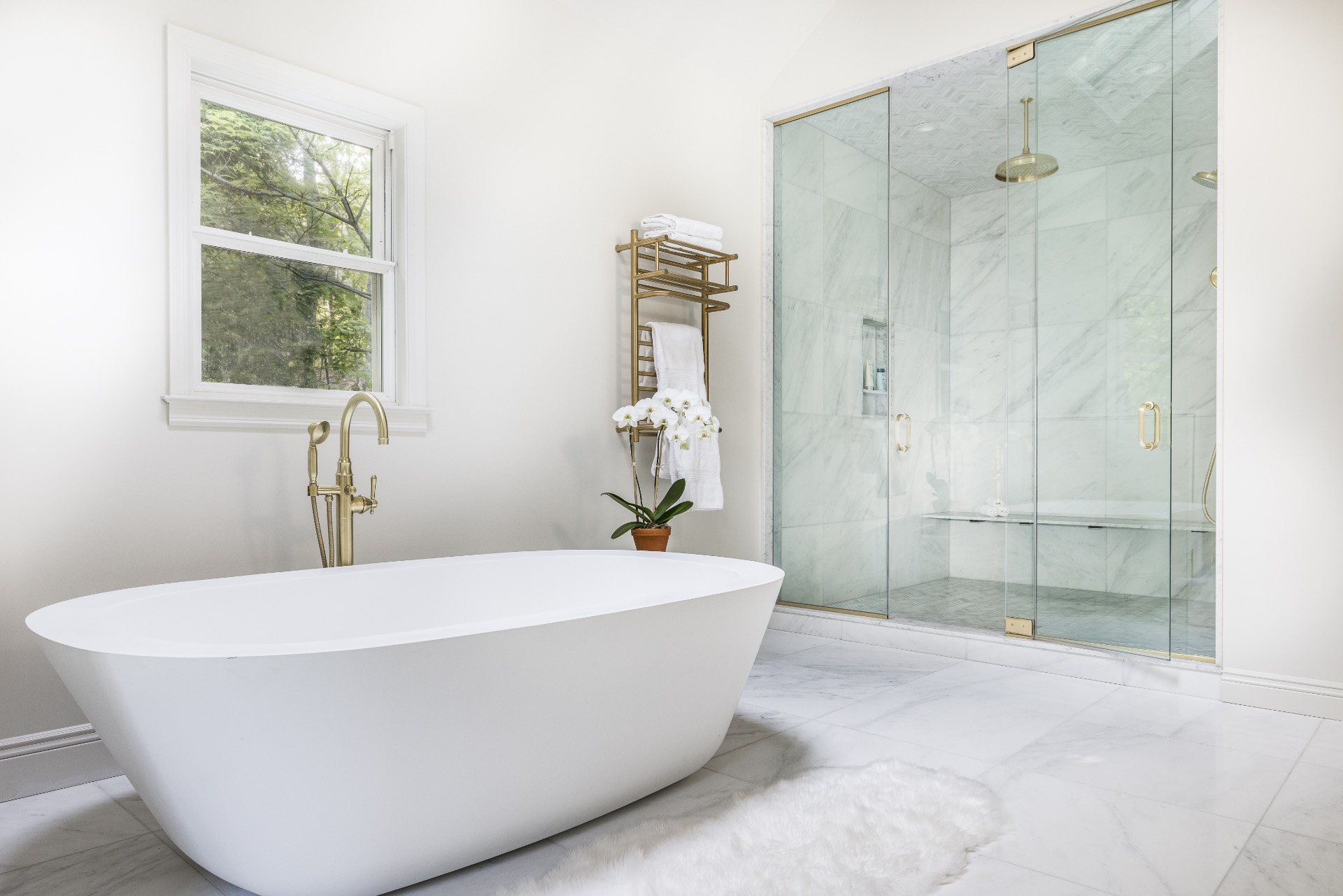 222 2 Holes Water Road East Hampton, NY 11937 - Photo 18 of 32 a white tub sitting next to a shower