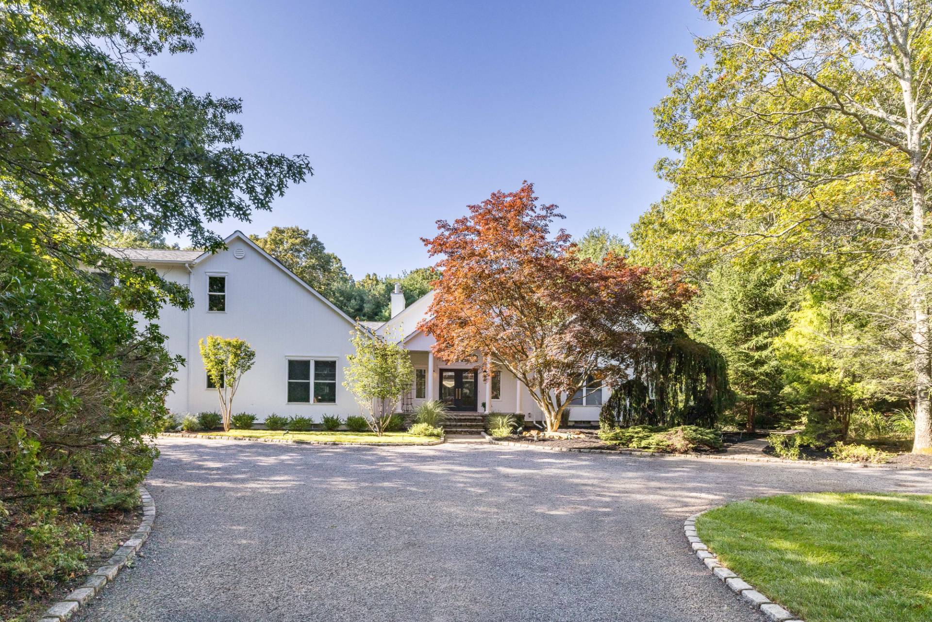 222 2 Holes Water Road East Hampton, NY 11937 - Photo 2 of 32 a view of a house with a tree and plants