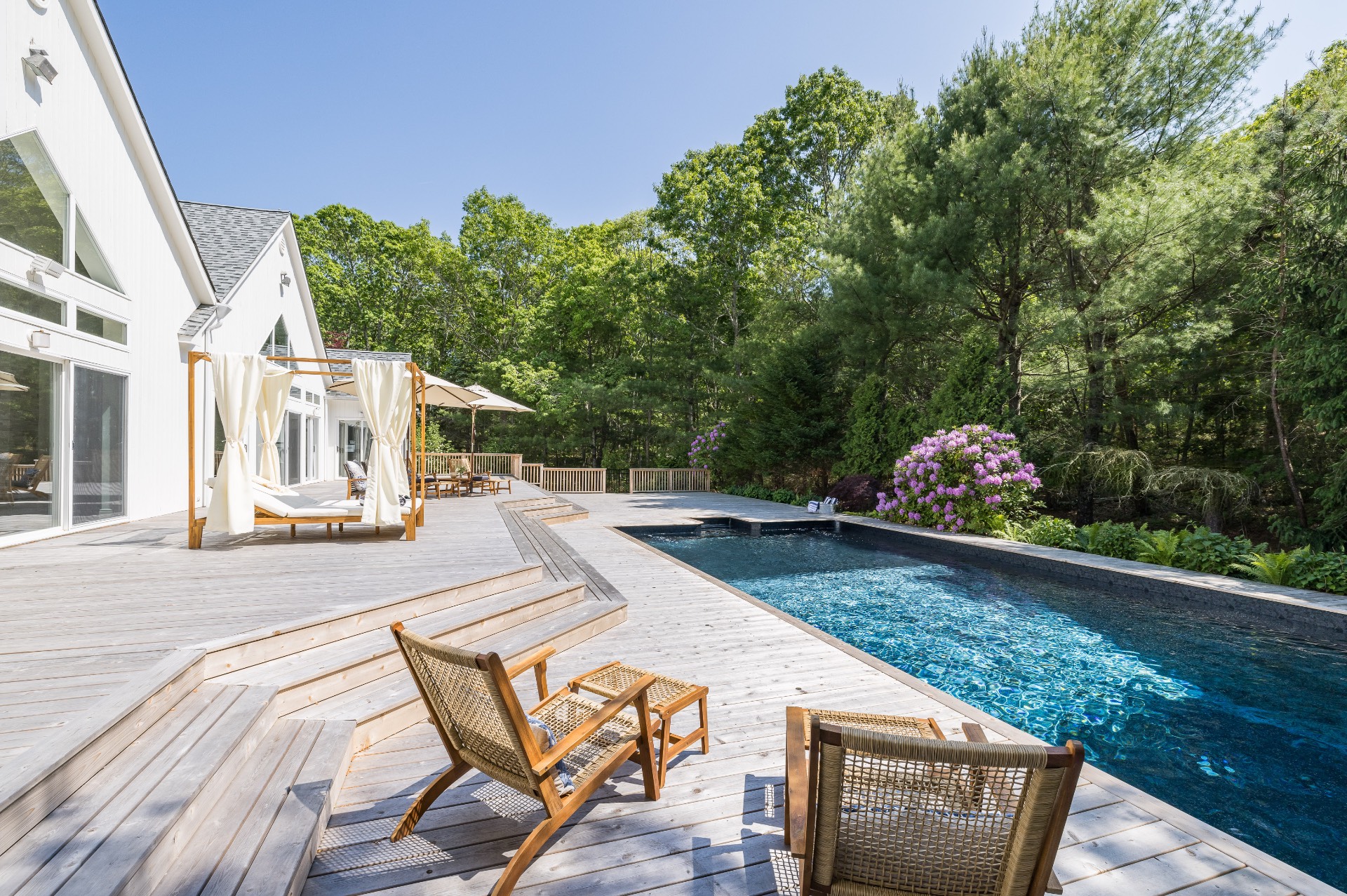 222 2 Holes Water Road East Hampton, NY 11937 - Photo 27 of 32 a view of a patio with table and chairs and potted plants