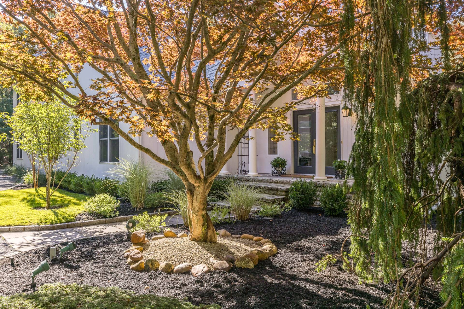 222 2 Holes Water Road East Hampton, NY 11937 - Photo 30 of 32 a front view of a house with a garden
