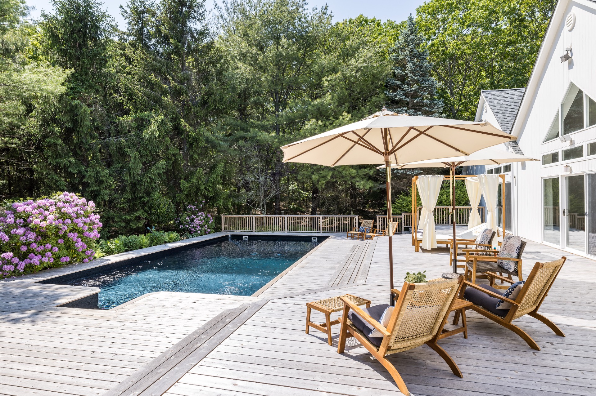 222 2 Holes Water Road East Hampton, NY 11937 - Photo 8 of 32 a view of a swimming pool with a lounge chair