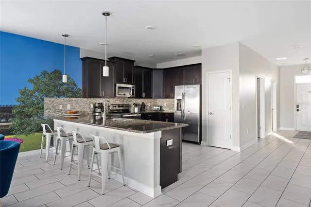 a kitchen with granite countertop a sink and cabinets