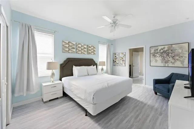 a spacious bedroom with a bed and a chandelier