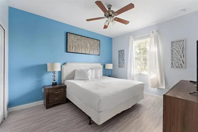 a bedroom with a large bed and a window