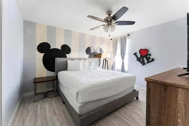 a bedroom with a large bed and a chandelier