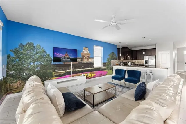a living room with furniture and kitchen view
