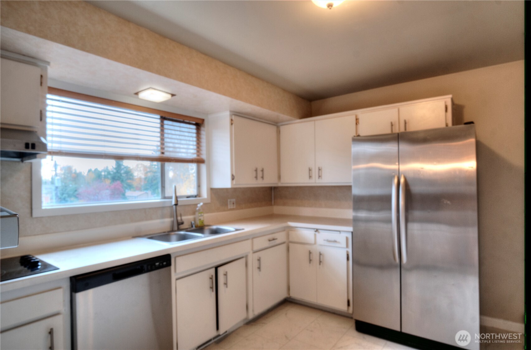 6605 South 127th Place Seattle, WA 98178 - Photo 11 of 28 a kitchen with a refrigerator sink and cabinets