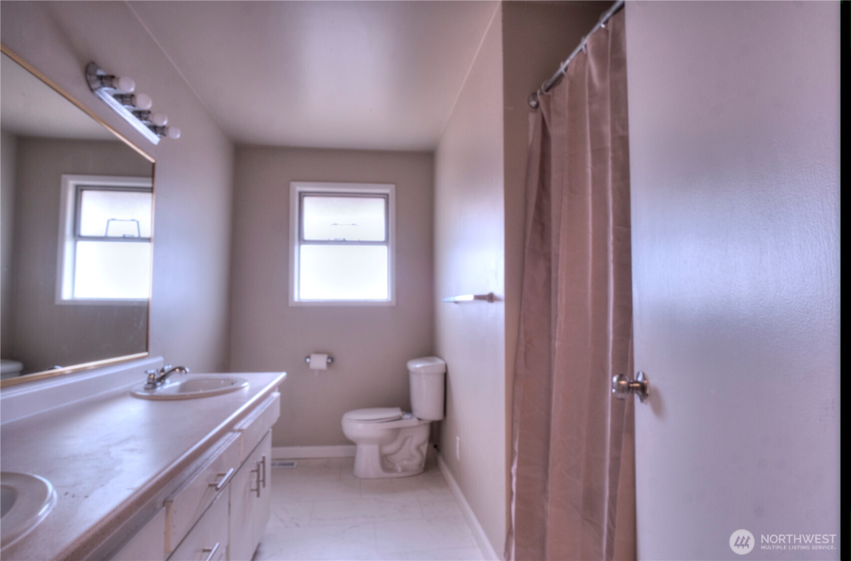 6605 South 127th Place Seattle, WA 98178 - Photo 13 of 28 a bathroom with a granite countertop sink mirror and toilet