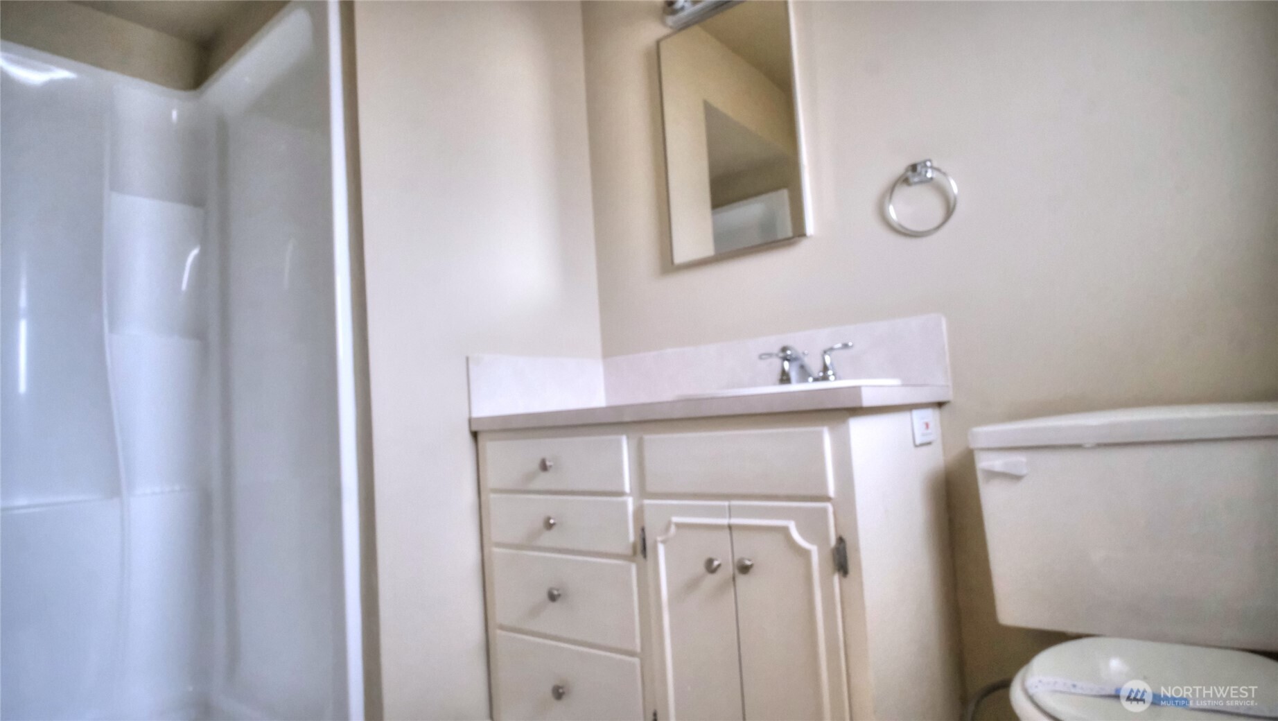 6605 South 127th Place Seattle, WA 98178 - Photo 15 of 28 a bathroom with a sink vanity mirror and toilet