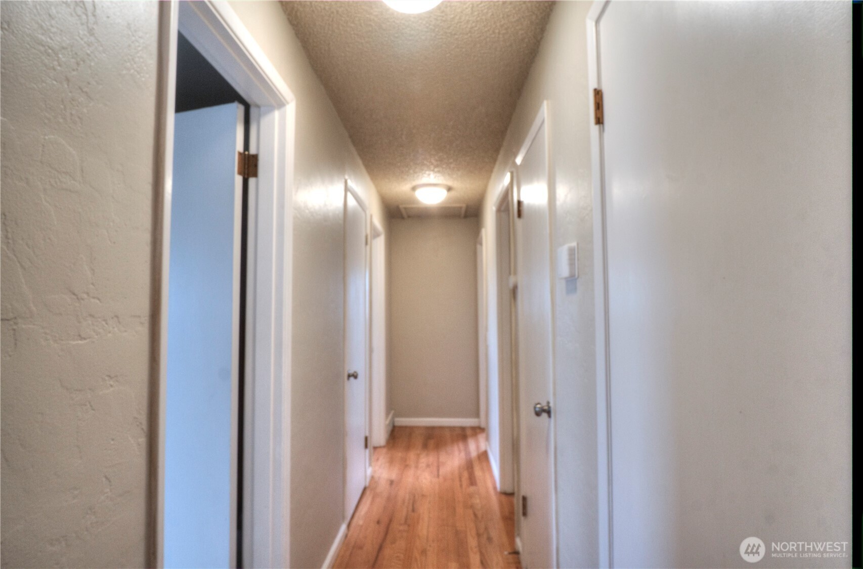6605 South 127th Place Seattle, WA 98178 - Photo 10 of 28 a view of a hallway with wooden floor