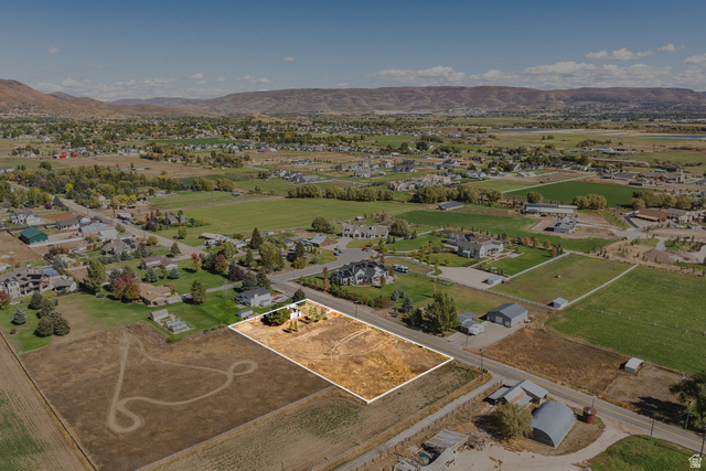 1160 Stringtown Road Midway, UT 84049 - Photo 23 of 26 Aerial perspective of suburban area with a mountain backdrop and property parcel outlined