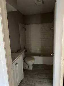 a bathroom with a toilet and a shower