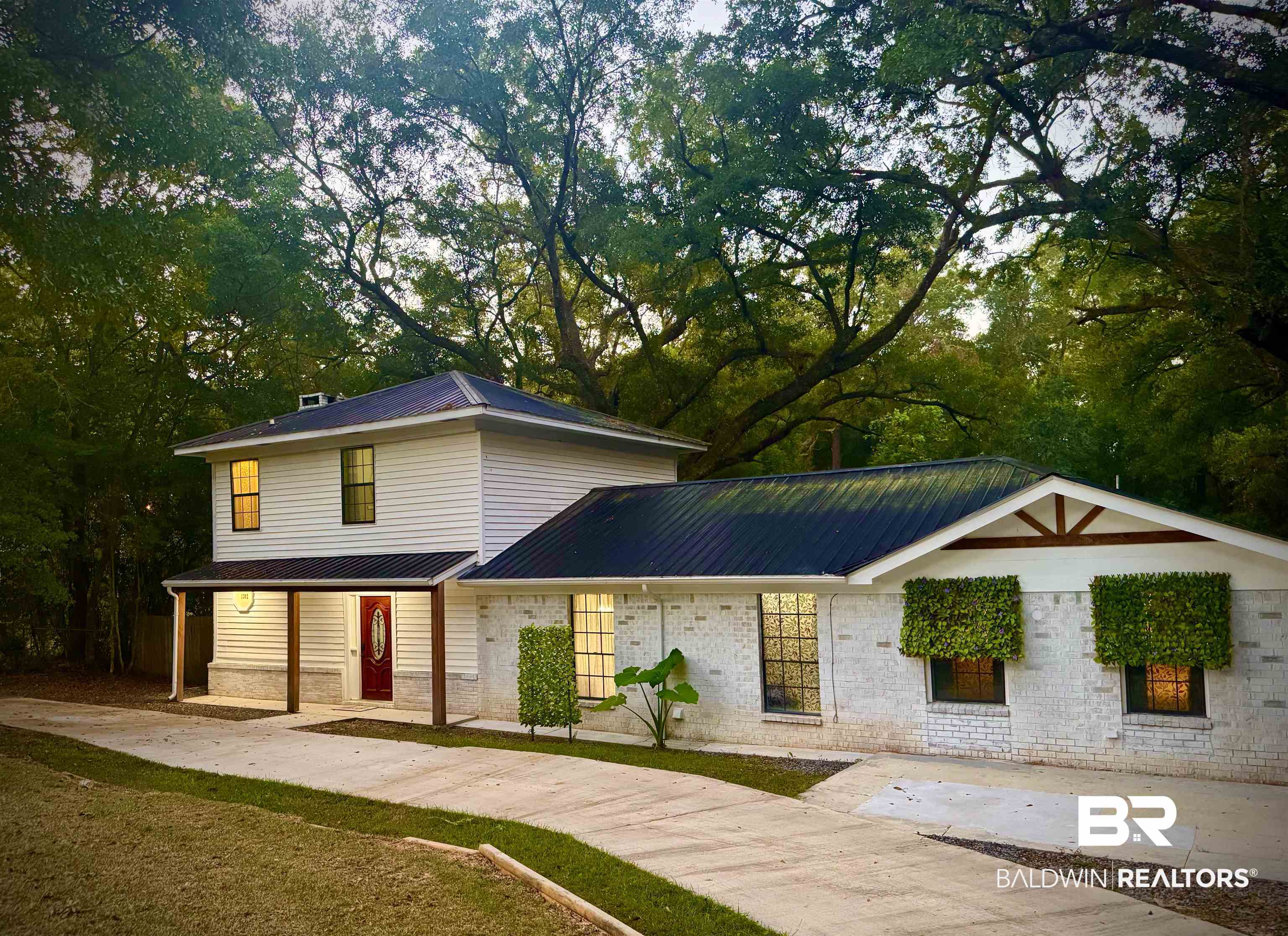 1302 Oak Street Daphne, AL 36526 - Photo 2 of 34 View of front of home with a metal roof and a porch