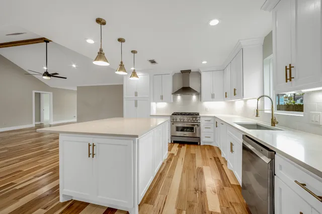 a bathroom with double vanity and a mirror