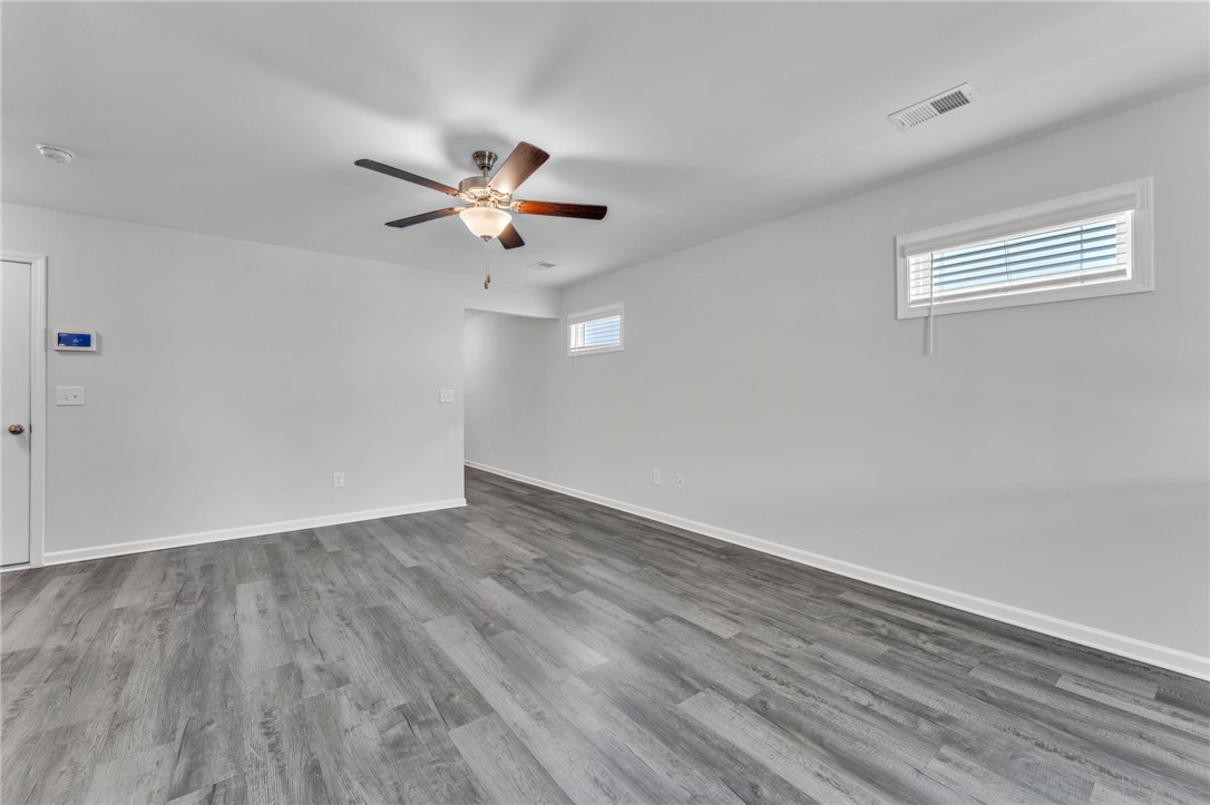 208 Samuel Street Pendleton, SC 29670 - Photo 5 of 32 Well-lit living area featuring rich hardwood flooring and a stylish ceiling fan.