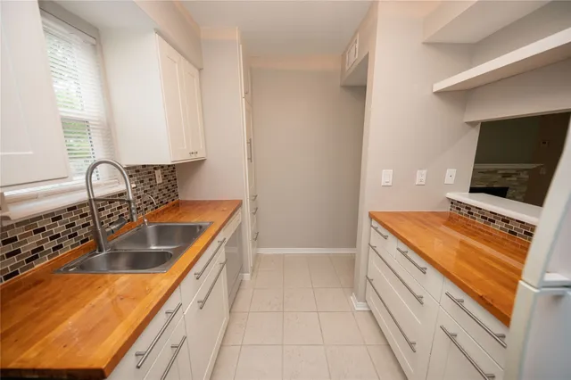 an empty room with a window and a ceiling fan