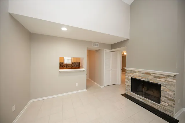 a view of a livingroom with wooden floor and kitchen space